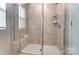 Elegant walk-in shower with sleek glass doors and marble-look tile at 260 Laura Elizabeth Ln, Clover, SC 29710