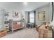 Charming Bedroom featuring a gray crib with orange accents, a play table, and a comfortable leather chair at 268 Laura Elizabeth Ln, Clover, SC 29710