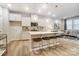 Modern kitchen with white cabinets, island seating, and open-concept living space at 268 Laura Elizabeth Ln, Clover, SC 29710