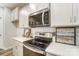 Modern kitchen with stainless steel oven and microwave with white cabinets and stone countertops at 268 Laura Elizabeth Ln, Clover, SC 29710