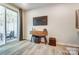 Living area featuring a mounted TV, stylish console table, and access to an outdoor patio at 280 Laura Elizabeth Ln, Clover, SC 29710