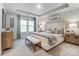 A serene main bedroom with a tray ceiling and an upholstered bed, offering a luxurious and restful retreat at 280 Laura Elizabeth Ln, Clover, SC 29710