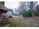 Spacious backyard with mature trees, and a storage building in the backyard at 2905 Maryland Ave, Kannapolis, NC 28083