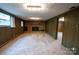 Spacious basement with a brick fireplace and wood paneling, offering a cozy retreat at 2905 Maryland Ave, Kannapolis, NC 28083