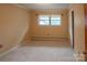 Bedroom with neutral carpet, beige walls, and a bright window for natural light at 2905 Maryland Ave, Kannapolis, NC 28083