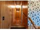 Wood paneled hallway leads to bedrooms with accent floral wallpaper and hardwood floors at 2905 Maryland Ave, Kannapolis, NC 28083