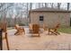 Outdoor fire pit surrounded by Adirondack chairs on the back patio at 298 Upper Stanley Rd, Stanley, NC 28164