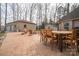 Spacious back patio with a dining table, fire pit, and detached garage at 298 Upper Stanley Rd, Stanley, NC 28164