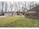 Expansive backyard with a brick patio, detached garage, and green grass at 298 Upper Stanley Rd, Stanley, NC 28164