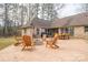 Expansive backyard with a fire pit, outdoor seating, patio, and mature trees, perfect for entertaining at 298 Upper Stanley Rd, Stanley, NC 28164