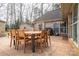 Spacious backyard with a stamped concrete patio, wooden furniture, and a charming fire pit at 298 Upper Stanley Rd, Stanley, NC 28164