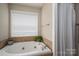 Bathroom with a jetted soaking tub and natural light at 298 Upper Stanley Rd, Stanley, NC 28164