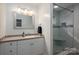 Bright bathroom featuring a glass door shower and a vanity with ample storage at 298 Upper Stanley Rd, Stanley, NC 28164