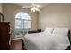 Bedroom with a large arched window providing ample natural light, ceiling fan, and desk at 298 Upper Stanley Rd, Stanley, NC 28164