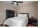 Bedroom features wood floors, a ceiling fan, and wardrobe cabinet with mirror at 298 Upper Stanley Rd, Stanley, NC 28164