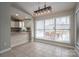 Bright dining area with tile floors, modern lighting, and a large window overlooking the outdoor patio at 298 Upper Stanley Rd, Stanley, NC 28164