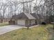 Well-maintained brick home featuring an attached two-car garage and a long driveway at 298 Upper Stanley Rd, Stanley, NC 28164