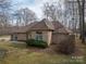 Brick home featuring manicured landscaping, arched window, and a well-kept lawn, blending comfort and style at 298 Upper Stanley Rd, Stanley, NC 28164