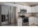 Modern kitchen with stainless steel appliances, white cabinetry, and ample counter space at 298 Upper Stanley Rd, Stanley, NC 28164