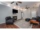 Cozy living room with a fireplace, a large leather armchair, and hardwood floors at 298 Upper Stanley Rd, Stanley, NC 28164