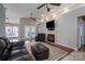 This expansive living room features wood floors, fireplace, and views to the screened porch at 298 Upper Stanley Rd, Stanley, NC 28164