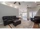 Comfortable living room with a large leather sofa, ceiling fan, and an open layout at 298 Upper Stanley Rd, Stanley, NC 28164