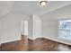 Simple bedroom with hardwood floors, window, and access to another room at 301 S Washington St, Monroe, NC 28112