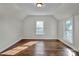 Simple bedroom with hardwood floors and two large windows at 301 S Washington St, Monroe, NC 28112