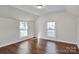 Spacious bedroom with hardwood floors and two large windows at 301 S Washington St, Monroe, NC 28112