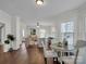 Bright dining area with hardwood floors and a view into the living room at 301 S Washington St, Monroe, NC 28112