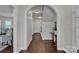 Bright hallway with hardwood floors and archways leading to other rooms at 301 S Washington St, Monroe, NC 28112