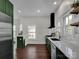 Modern kitchen with dark green cabinets and stainless steel appliances at 301 S Washington St, Monroe, NC 28112