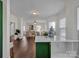 Modern kitchen with island, dark green cabinets, and white countertops at 301 S Washington St, Monroe, NC 28112