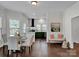 Modern kitchen with dark green cabinets, a breakfast bar, and hardwood floors at 301 S Washington St, Monroe, NC 28112