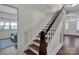 Classic staircase with wooden handrail and hardwood floors at 301 S Washington St, Monroe, NC 28112