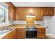 Kitchen with wood cabinets, a built-in oven, and a corner sink at 3013 Southampton Cir, Gastonia, NC 28056