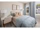 Cozy bedroom with neutral tones, soft blue accents, and a comfortable bed complemented by a desk and natural light at 3016 Finchborough Ct # 229, Charlotte, NC 28269