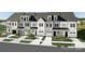 New townhouses with gray and white siding, two-car garages, and landscaping at 3016 Finchborough Ct # 229, Charlotte, NC 28269