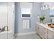 Modern bathroom featuring a glass-enclosed shower, vanity, and large mirror at 3038 Finchborough Ct # 234, Charlotte, NC 28269