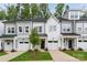 Three-unit townhome development showcasing modern gray exteriors and attached garages at 3038 Finchborough Ct # 234, Charlotte, NC 28269