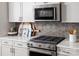 Close-up of the kitchen featuring stainless steel oven/cooktop and stylish backsplash at 3038 Finchborough Ct # 234, Charlotte, NC 28269