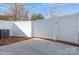 Private backyard with a concrete patio and white vinyl fence at 33 Woodsdale Se Pl, Concord, NC 28025