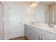 Modern bathroom with dual vanity, shower, and grey cabinets at 33 Woodsdale Se Pl, Concord, NC 28025