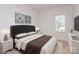 Bedroom with a king-size bed, dark headboard, and neutral decor at 33 Woodsdale Se Pl, Concord, NC 28025