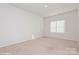 Bright bedroom with plush carpet and a window at 33 Woodsdale Se Pl, Concord, NC 28025