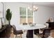 Dining room with a round table, chandelier, and large window at 33 Woodsdale Se Pl, Concord, NC 28025