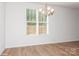 Bright dining room features hardwood floors and a chandelier at 33 Woodsdale Se Pl, Concord, NC 28025