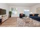 Living room with hardwood floors, comfy seating, and a large TV at 33 Woodsdale Se Pl, Concord, NC 28025