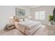 Spacious bedroom with plush carpet and a large window at 33 Woodsdale Se Pl, Concord, NC 28025