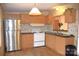 Simple kitchen with wood cabinets and stainless steel refrigerator at 3300 Bendwood Rd, Newton, NC 28658